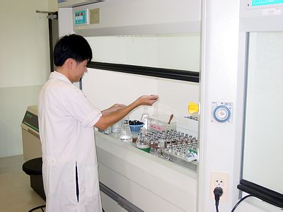 A technician analyzing samples in a pesticide residue laboratory in Thailand